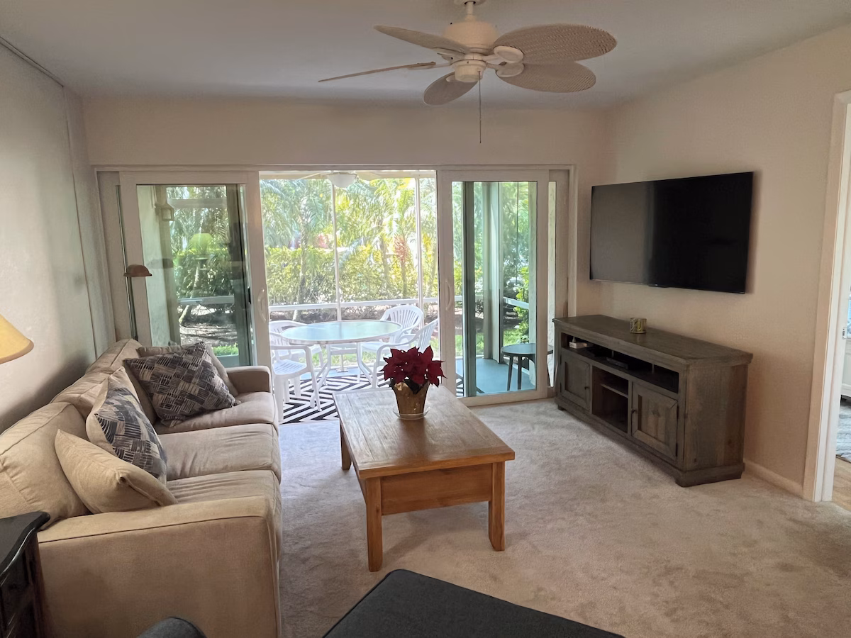 Bright living room with sleeper sofa and balcony